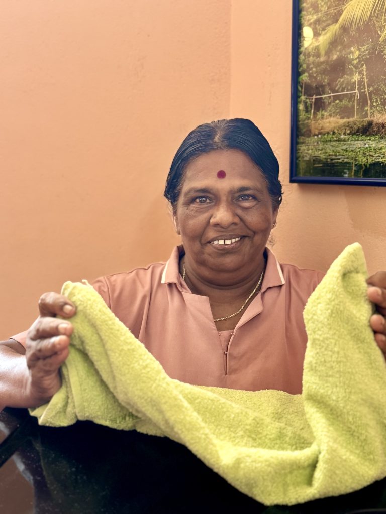 Sathi - female therapist at Prakruthi Ayurveda, Cherai Beach, preparing the towel for the steam box